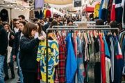 Wide horizontal editorial photo, 1200x900 minimum, optimized for Google Discover, 4:3 aspect ratio. Realistic photojournalistic image of the main subject of the news: a dense rack of eye-catching vintage clothing from the 90s and 2000s at a trendy Madrid